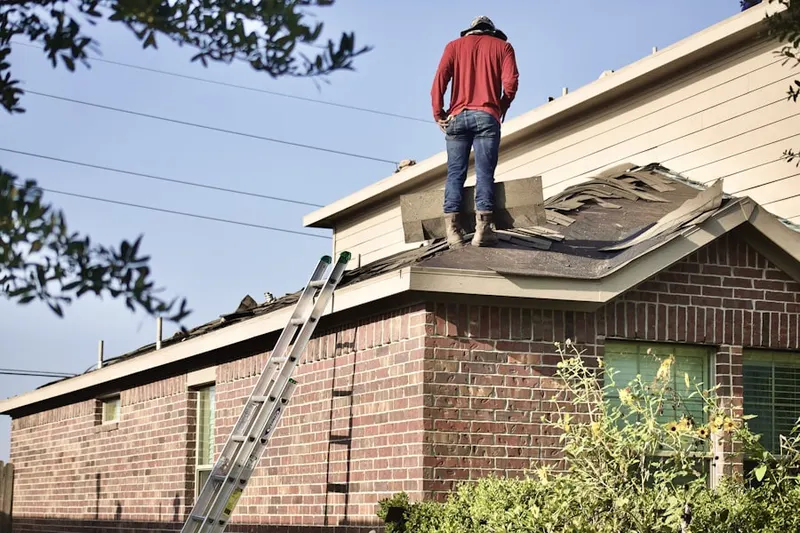 Professional roofer working on a residential roof in East Central North